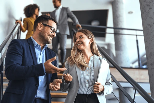 Professionals confidently interacting in a modern office environment—representing HIDM’s job-oriented modules in digital marketing, tailored to prepare students for real-world careers in SEO, PPC, content marketing, Google Ads, and social media strategy.