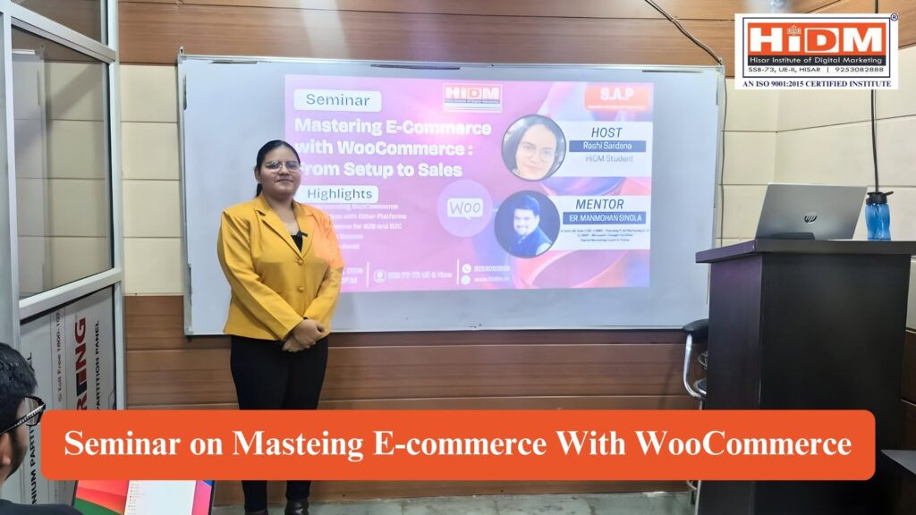 A presenter stands in front of a projector screen displaying the HiDM seminar poster titled "Mastering E-Commerce with WooCommerce: From Setup to Sales." The classroom includes a podium with a laptop, a whiteboard, and students attending the session. The image highlights a HiDM SAP (Student Activity & Programme) seminar focused on WooCommerce and e-commerce learning.